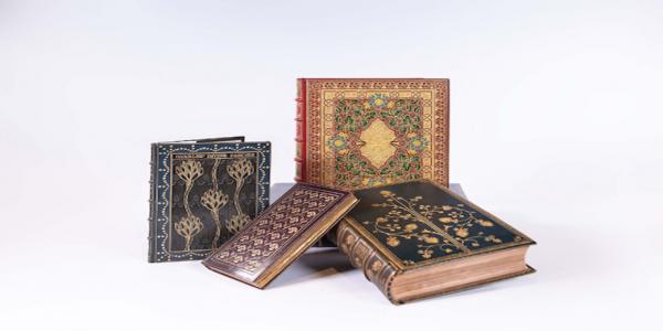 Four intricate books displayed on a white background 