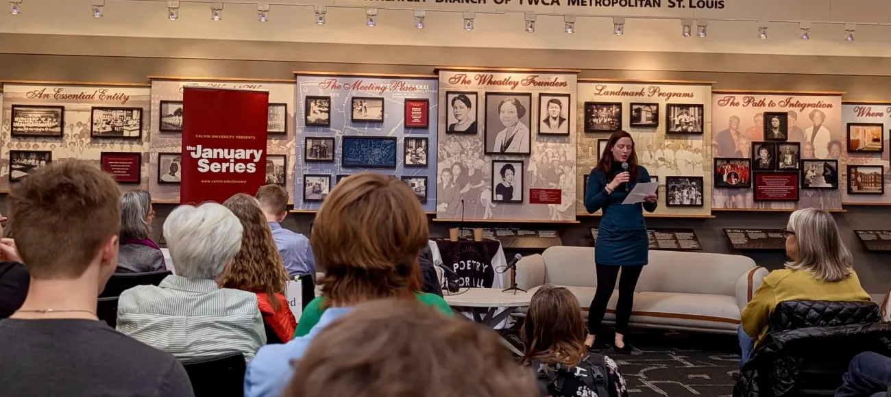 "Laura Evers stands in front of an audience at the Phyllis Wheatley YWCA"