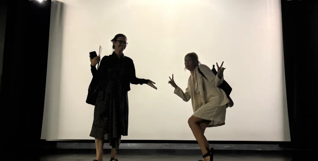 "silhouetted figures on a stage"