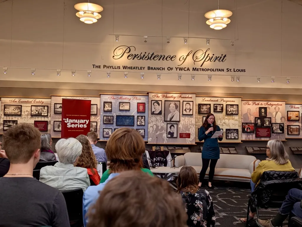 "Laura Evers stands in front of an audience at the Phyllis Wheatley YWCA"