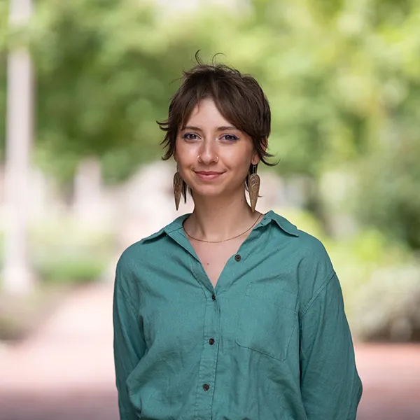 "woman wearing a green shirt in an outdoor setting"