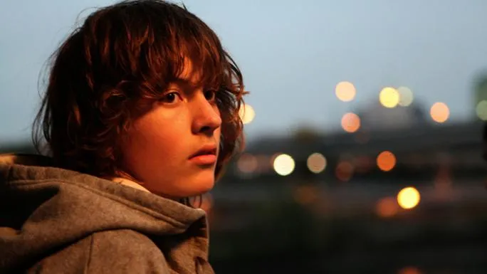 Publicity image from Paranoid Park of the main character looking slightly off camera at dusk.