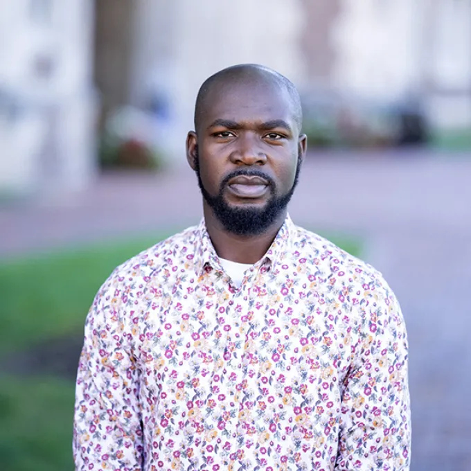 "Photo of a man wearing a patterned shirt"