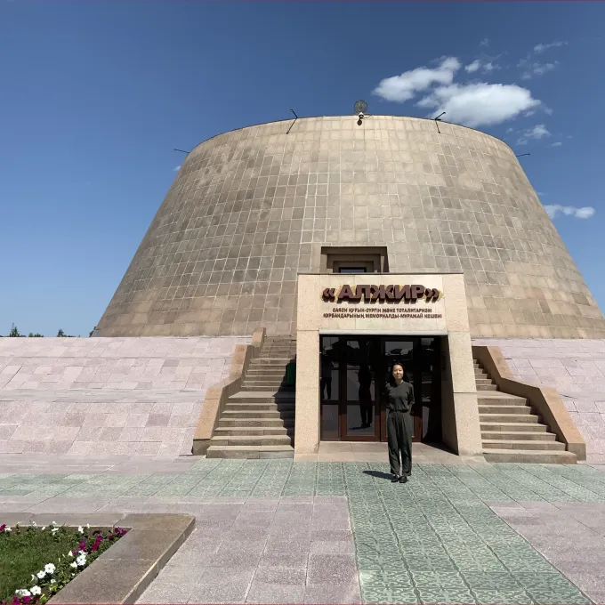 "woman standing in front of a building"