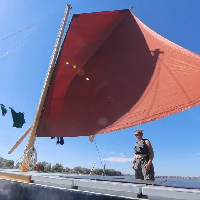 "This image shows a woman standing on a boat on the Mississippi River."