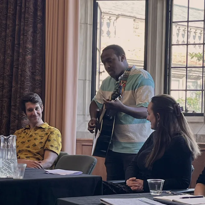 G’Ra Asim, Assistant Professor of English, plays guitar and sings